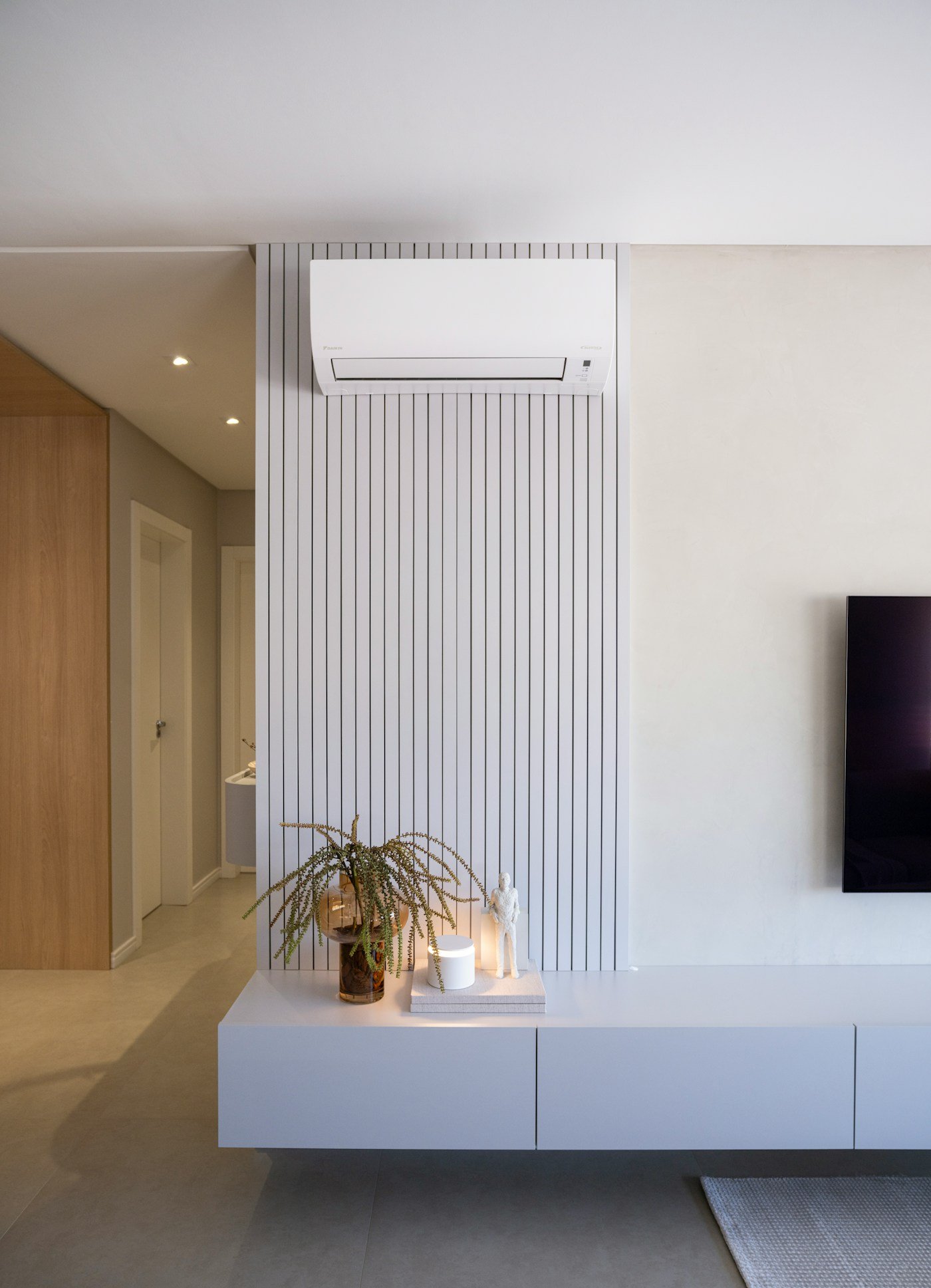 A premium modern living room with a professionally installed wall-mounted air conditioning unit